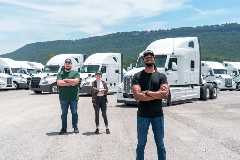 Three proud Independent Owner Operators standing in front of TEL trucks